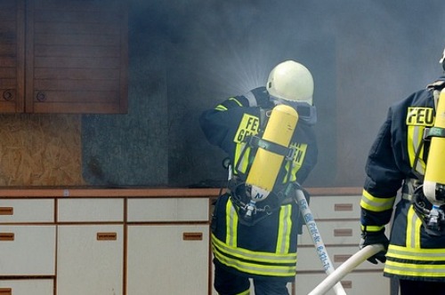 Bomberos apagando un fuego en una cocina, provocado por un mal uso